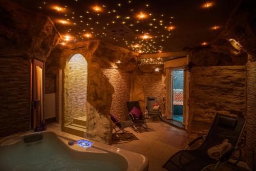a large bathroom with a tub with lights on the ceiling at Hotel Atrium Garni in Passau