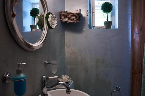 a bathroom with a sink and a mirror at Moorea Country Houses in Petalidhion