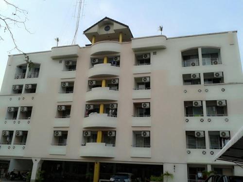 a white building with a bird on top of it at M In Korat Service Apartment in Nakhon Ratchasima