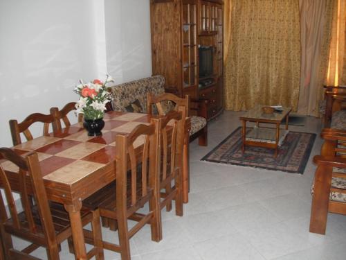 a living room with a wooden table and chairs at Reemyvera in Hurghada