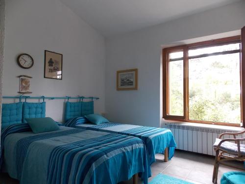 a bedroom with two beds and a window at B&B Sette Fratelli in San Gregorio