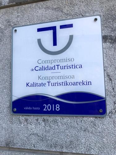 a sign on the side of a building at Pensión Basagoiti in Getxo