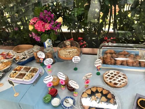 a table with pastries and other food items on it at Settessenze Residence & Rooms in Agropoli