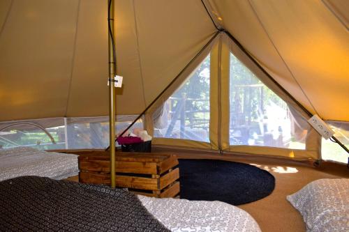 a room with two beds and a tent at Camping Alpujarras in Laroles