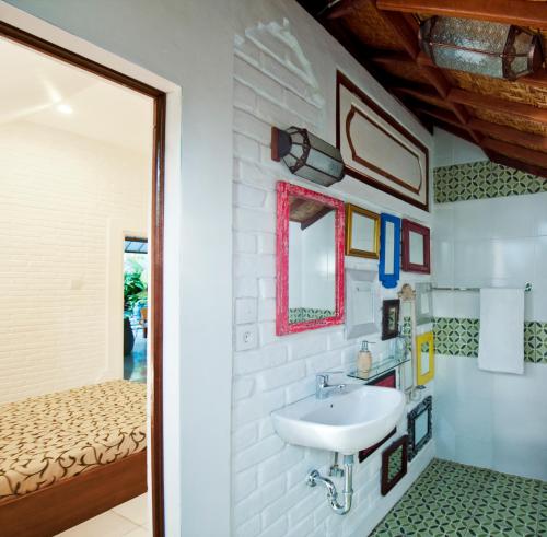 a bathroom with a sink and a bed at 3BR Villa Hari - Minggu Villas Seminyak in Seminyak