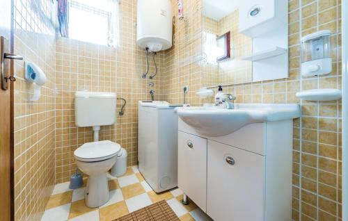 a bathroom with a toilet and a sink at Villa Stone Medal in Drniš