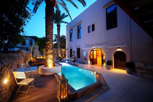 a hotel room with a pool and a balcony at Pepi Boutique Hotel (Adults Only) in Rethymno