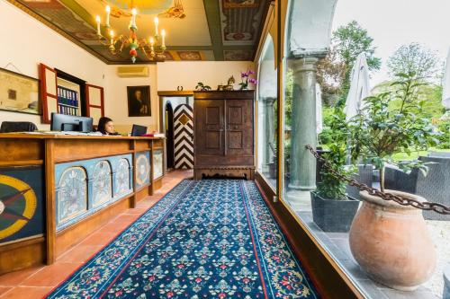 a lobby of a restaurant with a rug on the floor at Hotel Schloss Leonstain in Pörtschach am Wörthersee