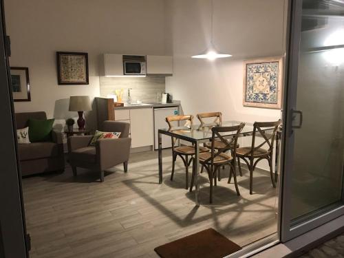 a dining room and living room with a table and chairs at A Gosto in Tomar