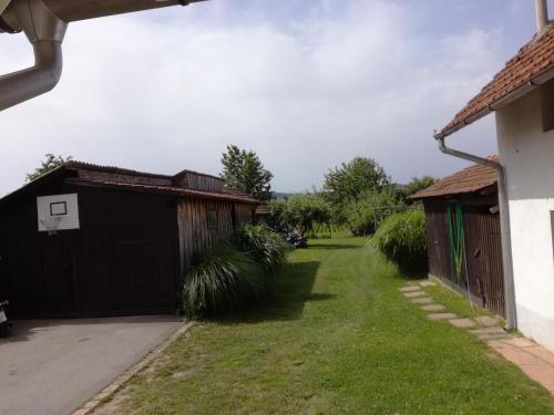 a backyard with two garages and a basketball hoop at Apartmani Oletić 4* in Sveti Martin na Muri