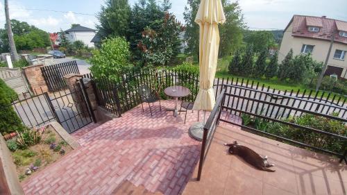 a patio with an umbrella and a table and a chair at Zielone Zacisze in Zagnańsk