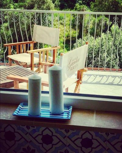 a balcony with a chair and two stacks of paper towels at Hotel Garden Riviera in Santa Maria di Castellabate