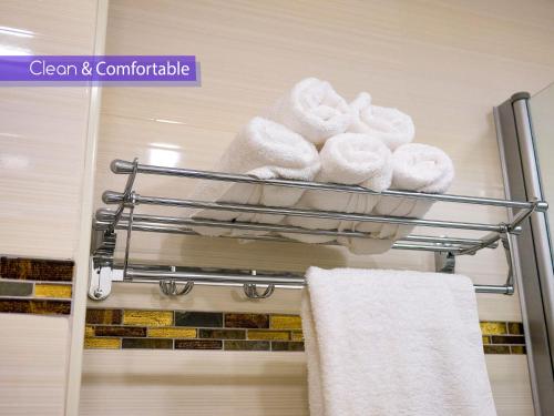 a towel rack with towels on it in a bathroom at FaRoyal Luxury Suite in Eilat