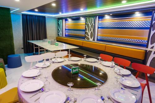 a dining room with a table with plates and glasses at Star Plaza Hotel in Dagupan