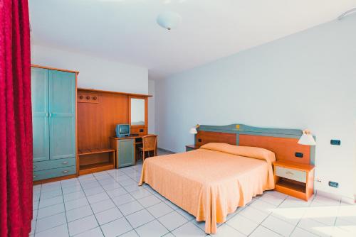 a bedroom with a bed and a red curtain at Apulia Hotel Corigliano Calabro in Corigliano Calabro