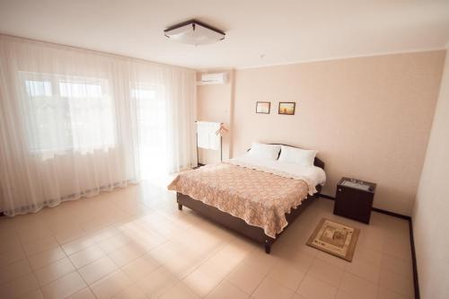 a bedroom with a bed and a large window at Picnic Park in Shenggeldi