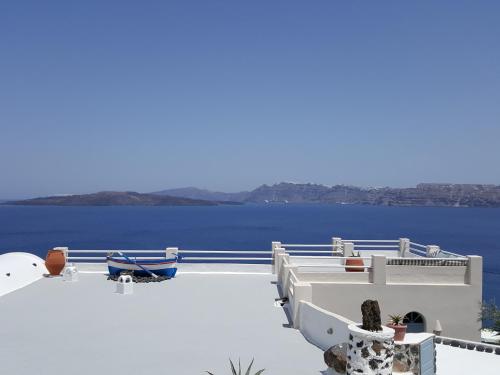 a white building with a view of the water at Kokkinos Villas in Akrotiri