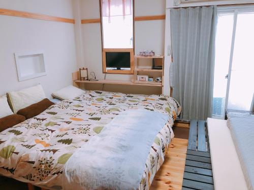 a bedroom with a large bed and a couch at Ryokoheya Hankyukan in Osaka