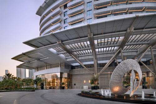 a large building with a sculpture in front of it at Address Downtown in Dubai