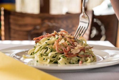 a plate of pasta with a fork on a table at Penzion Ovečka in Nýdek
