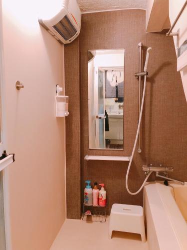 a bathroom with a sink and a mirror at Ryokoheya Hankyukan in Osaka