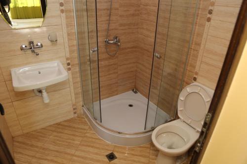a small bathroom with a toilet and a sink at Complex Trakite in Elkhovo