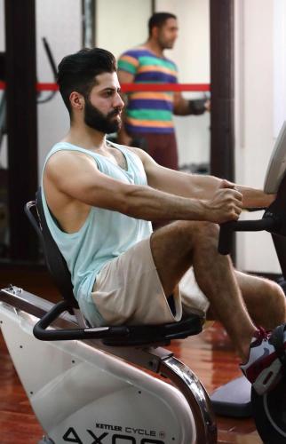 a man sitting on a chair in a gym at Al Hayat Hotel Suites in Sharjah
