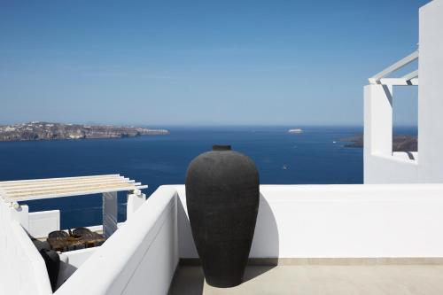 a black vase sitting on the side of a building at Volcano View by Caldera Collection in Fira