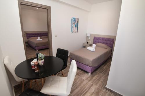 a small room with a bed and a table and a bedroom at Del Mar 'Adults Only' in Stalida