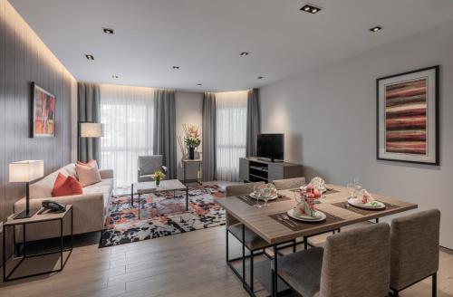 a living room with a couch and a table at Le Grove Serviced Residences in Singapore