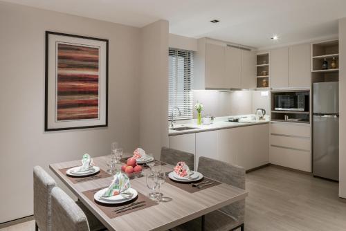 a kitchen and dining room with a table and chairs at Le Grove Serviced Residences in Singapore