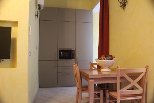 a kitchen with a table with a bowl of fruit on it at Residenza San Calisto in Rome