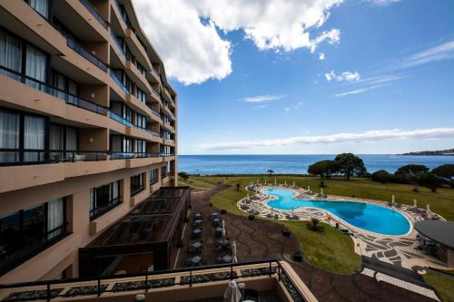 uma vista para a piscina a partir da varanda de um hotel em Pestana Bahia Praia Nature & Beach Resort em Vila Franca do Campo