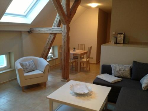 a living room with a couch and a table at Ferienwohnung Eckloff in Lutherstadt Wittenberg