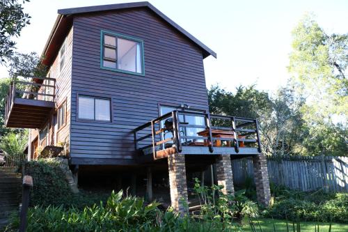 a house with a balcony on the side of it at Allan Grove 2 in Knysna