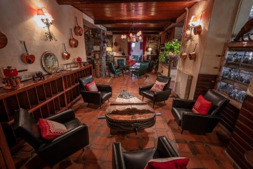 a bar with chairs and a table in a room at Hotel La Bonne Auberge in Saint-Martin-Vésubie