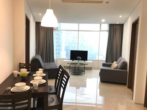 a living room with a dining table and a couch at VORTEX SUITES KLCC by PNUT With NETFLIX in Kuala Lumpur