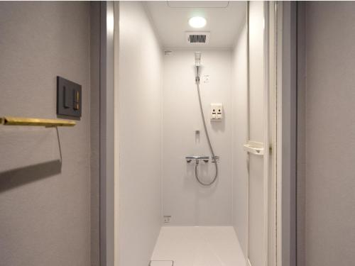 a shower in a bathroom with a toilet at Resters Bed&Co. in Kumamoto
