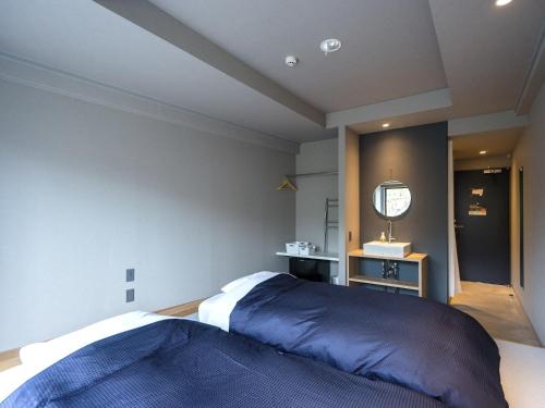 a bedroom with a large bed and a mirror at Resters Bed&Co. in Kumamoto