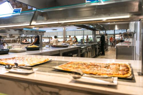 a restaurant kitchen with two pizzas on a counter at RVHotels Ametlla Mar in L'Ametlla de Mar