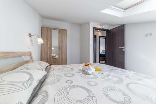 a bedroom with a large bed with a stuffed animal on it at Apartments The heart of Croatia in Pirovac