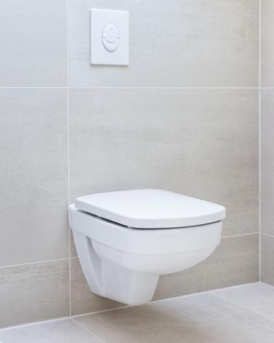 a white toilet in a bathroom with a white wall at Apartments The heart of Croatia in Pirovac