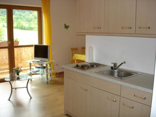 a kitchen with a sink and a counter top at Ferienhaus Beyer in Unterwössen