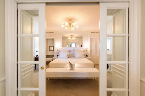 a bedroom with two beds and a mirror at Relais La Speranzina in Sirmione