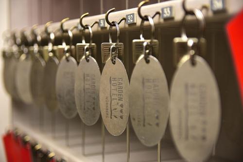 a row of silver utensils hanging on a rack at Garden Hotel in Nürnberg