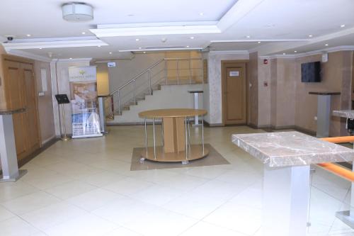 a room with a table and stairs in a building at Momona Hotel in Addis Ababa
