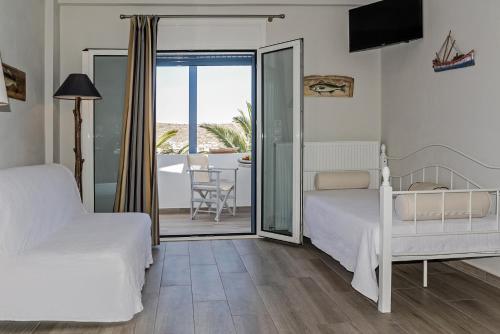 Posteľ alebo postele v izbe v ubytovaní Avlemonas Bay Sea Houses.