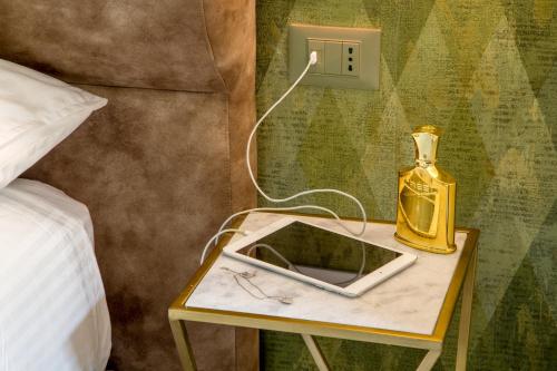 a table with a phone and a bottle on it at GCF Luxury Suites, Guest house in Rome