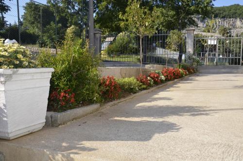 a row of flowers in a park with a fence at Apartments Lilly in Rijeka