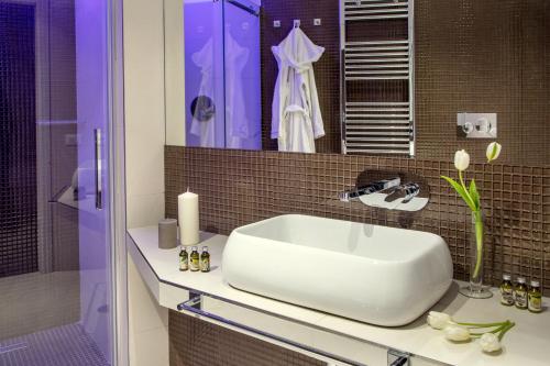 a bathroom with a large white sink on a counter at GCF Luxury Suites, Guest house in Rome